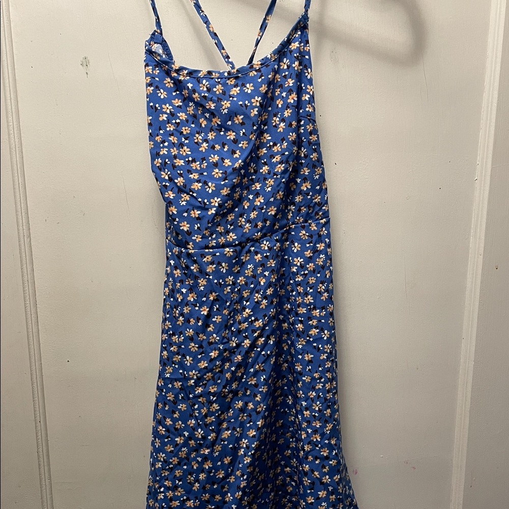 a blue floral dress, open back with criss cross, never worn but no tags.